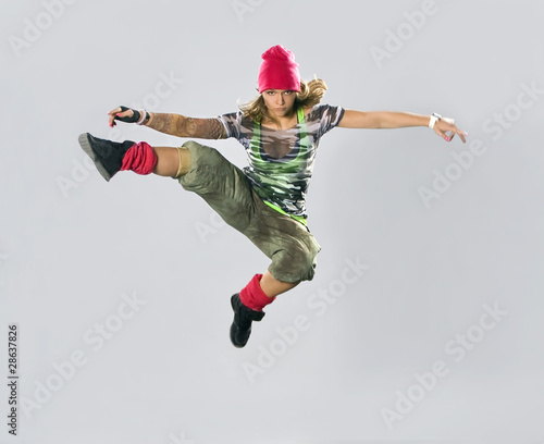 Fototapeta Naklejka Na Ścianę i Meble -  Teenage girl dancing breakdance in action