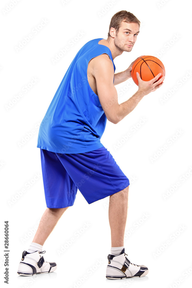 Full length portrait of a basketball player posing with a ball