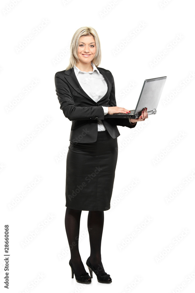 Full length portrait of a businesswoman working on a laptop Full length portrait of a businesswoman working on a laptop