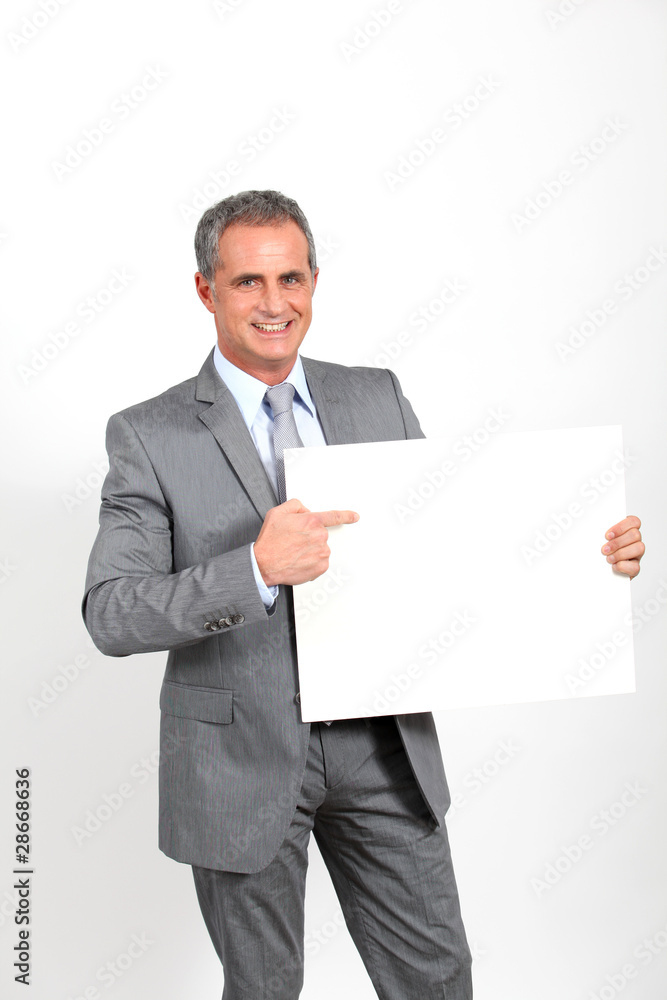 Smiling businessman showing whiteboard Smiling businessman showing whiteboard