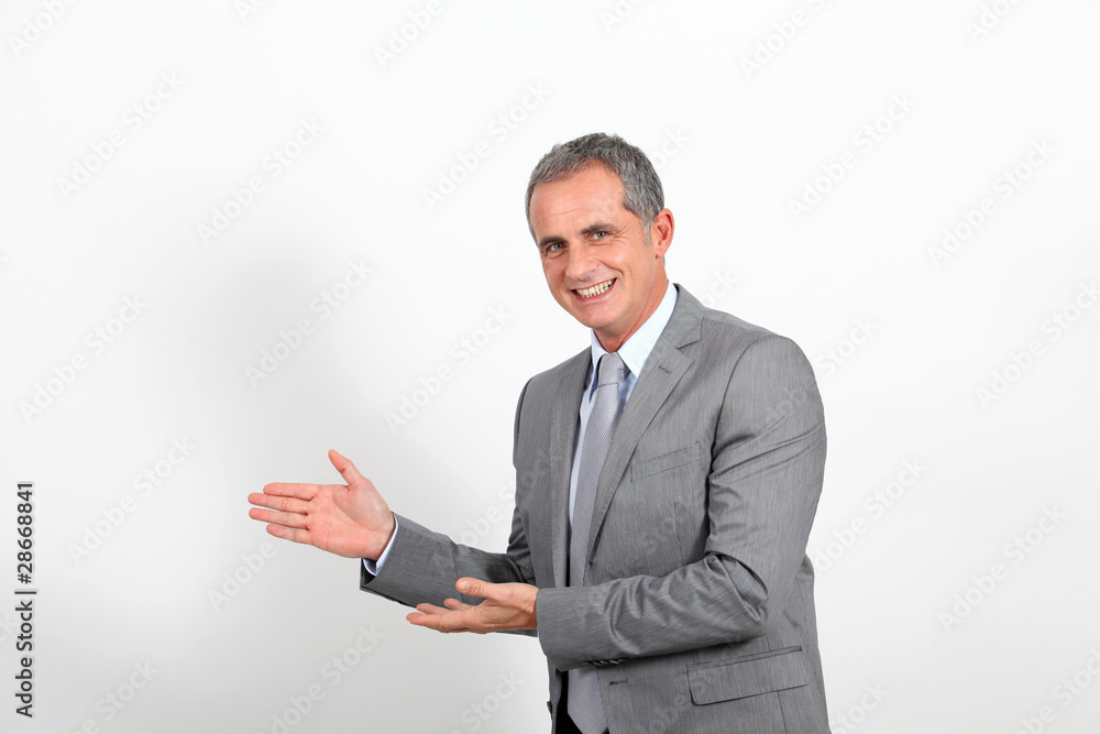 Smiling businessman showing whiteboard Smiling businessman showing whiteboard