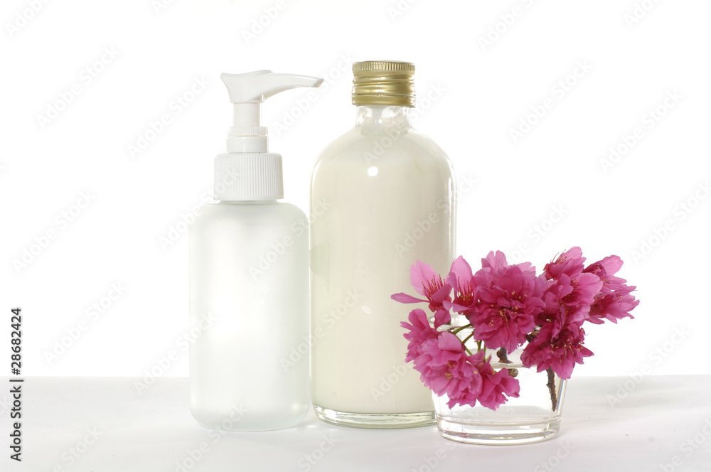 bottle of body lotion with red cherry flower