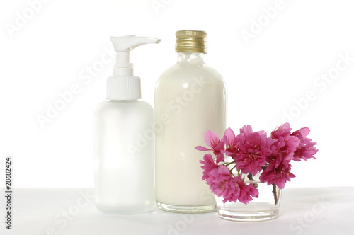 bottle of body lotion with red cherry flower