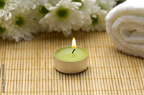 Spa composition. Towel  candle and flowers.