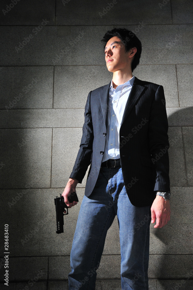 Asian Man with a Gun in shadow Asian Man with a Gun in shadow