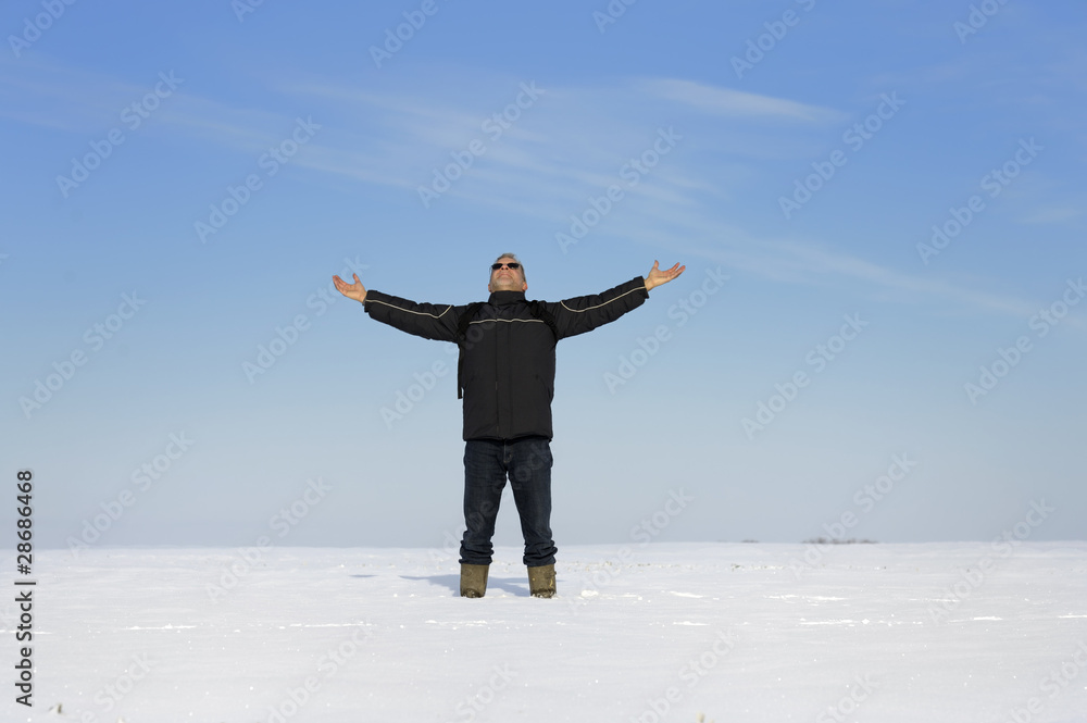 adult man in winter landscape looking up adult man in winter landscape looking up