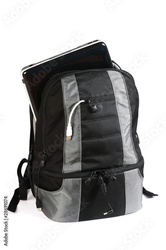 Backpack with a laptop inside isolated on white background