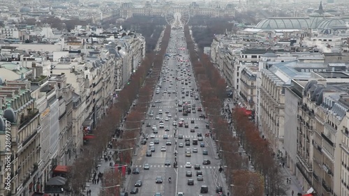 lot of cars and pedestrains on street of Paris photo