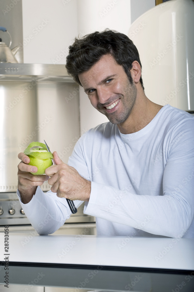 Fototapeta premium man peeling an apple