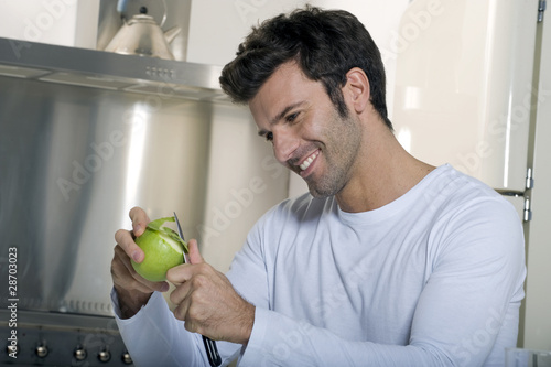 man peeling an apple