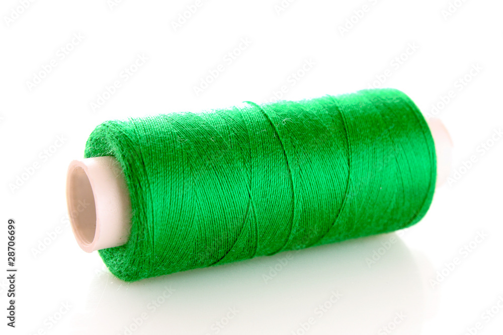 green bobbin thread isolated on white green bobbin thread isolated on white