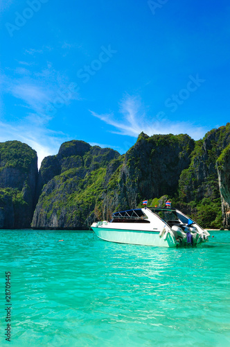 Motor boat on turquoise water of Maya Bay lagoon, Phi Phi island