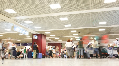 People with luggage in airport.