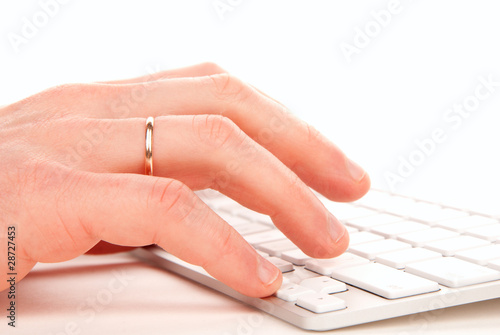 Hands typing on computer laptop keyboard