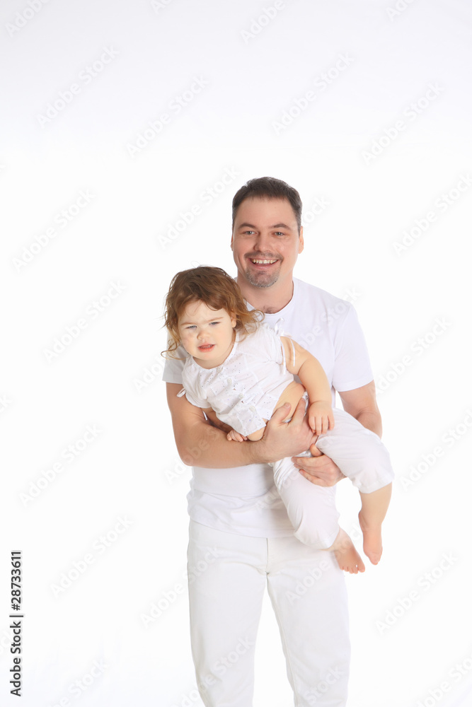 The father holds the little daughter in his arms.