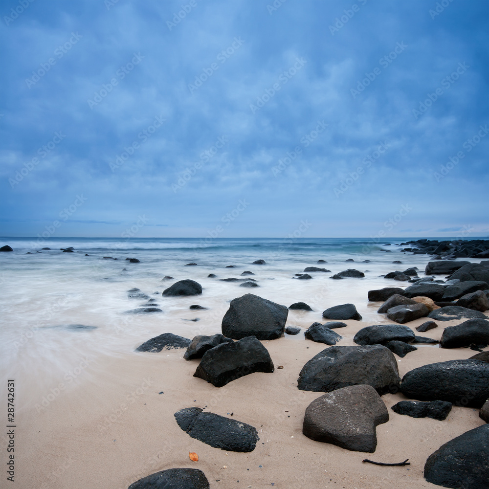 rock on the beach on cloudy morning