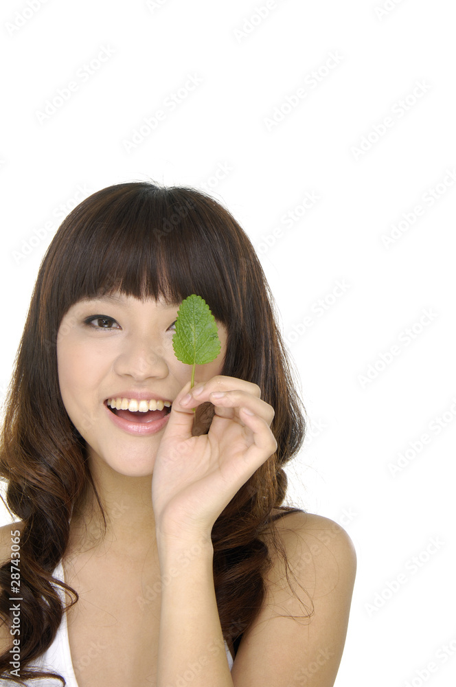 Close up girl holding green leaf Close up girl holding green leaf