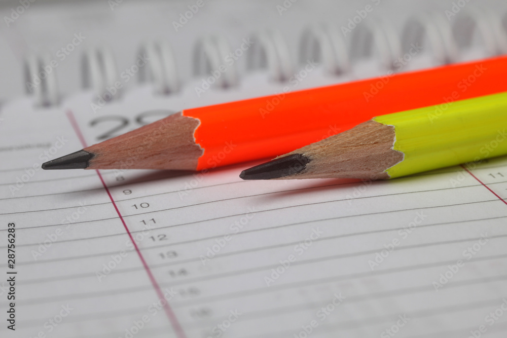 Pencils laying on spiral notebook or notepad Pencils laying on spiral notebook or notepad