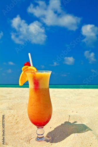 Fruity cocktail is on a beach