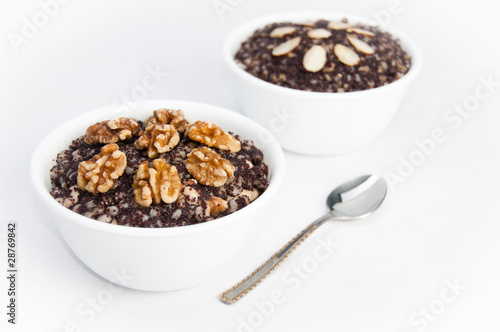 Two bowls of traditional Kutia dessert with a spoon on isolating