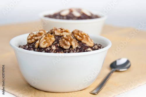 Two bowls with traditional Christmas kutia dessert on yellow nap