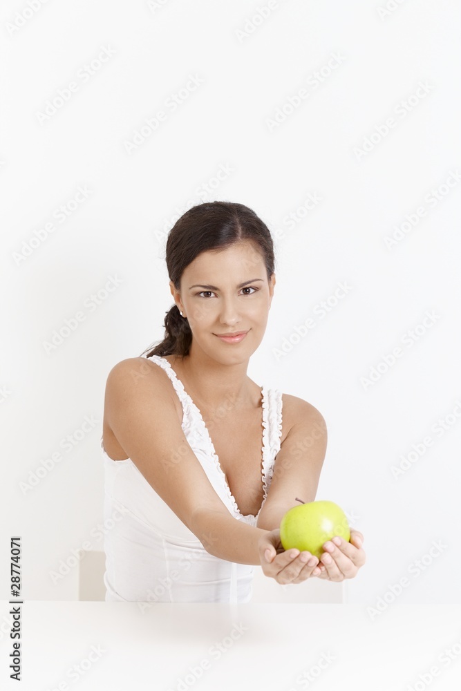 Attractive girl smiling with apple in hands Attractive girl smiling with apple in hands