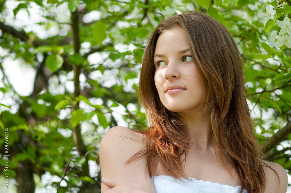 Beautiful young woman relaxing in apple tree garden Beautiful young woman relaxing in apple tree garden