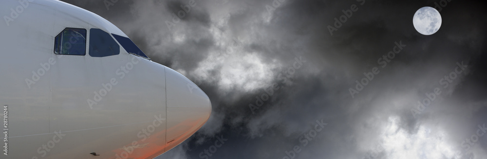 Naklejka premium airplane moon and dark sky