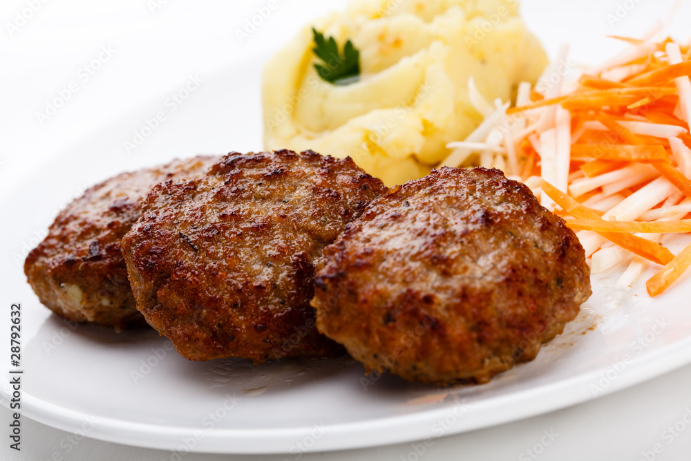 Fried steaks with potatoes and vegetable salad