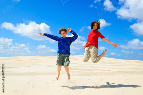 Kids jumping on desert