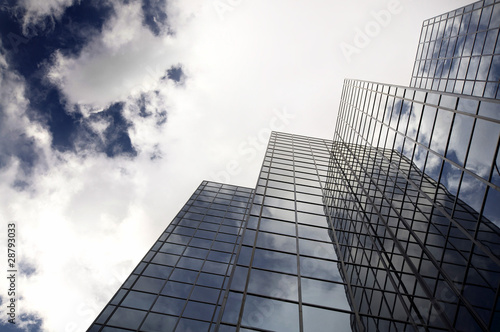 Photography Modern office building with cloud reflection in window.