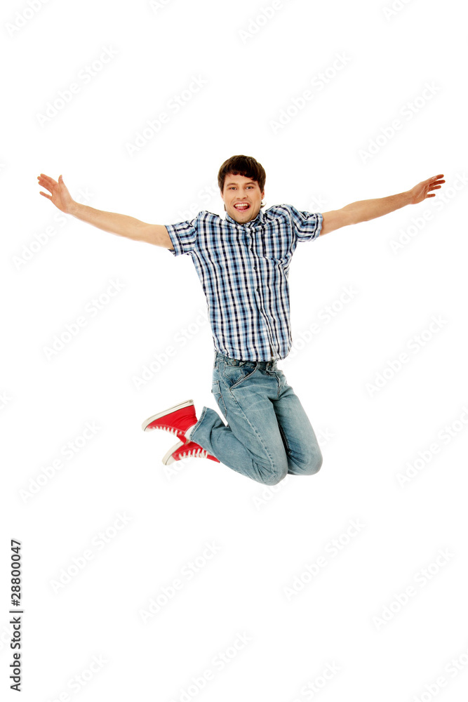 Young happy caucasian man jumping in the air