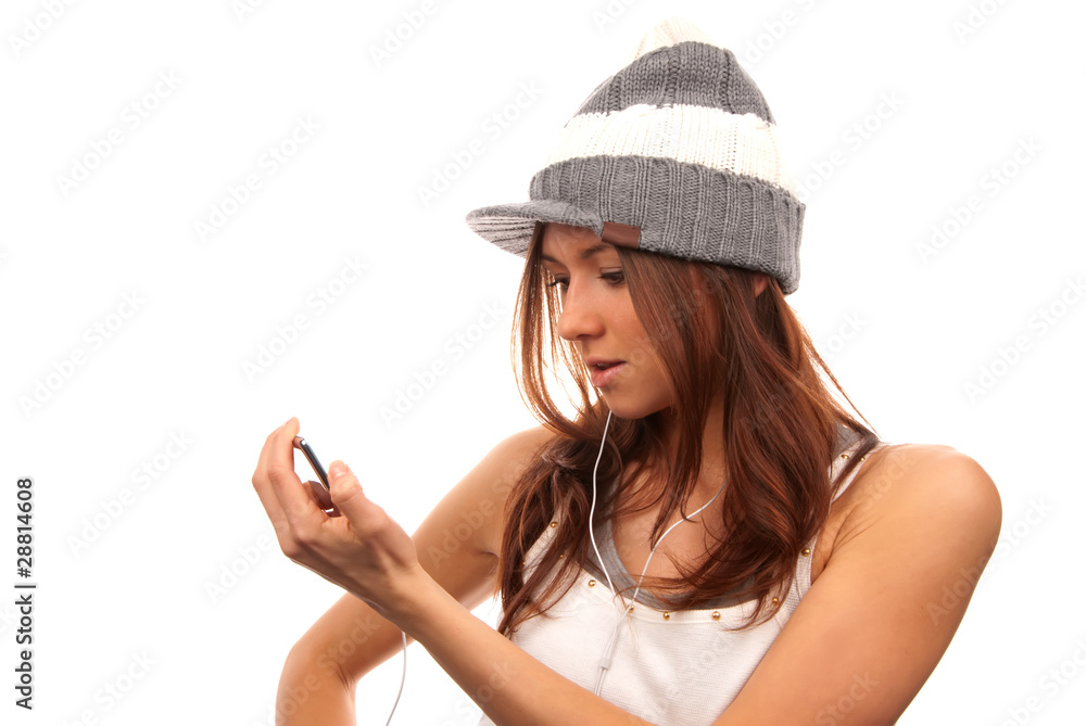 Female looking at cell phone in white headphones Female looking at cell phone in white headphones