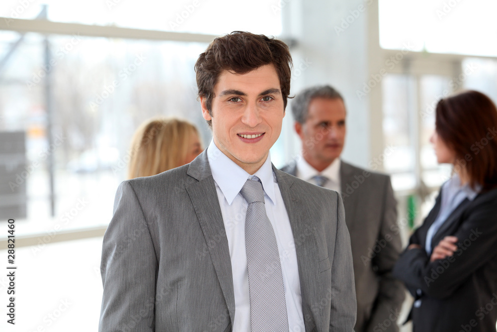 Businessman standing in front of group of business people