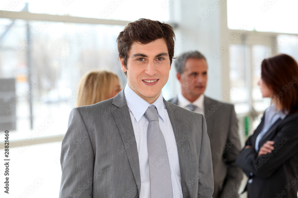 Businessman standing in front of group of business people Businessman standing in front of group of business people