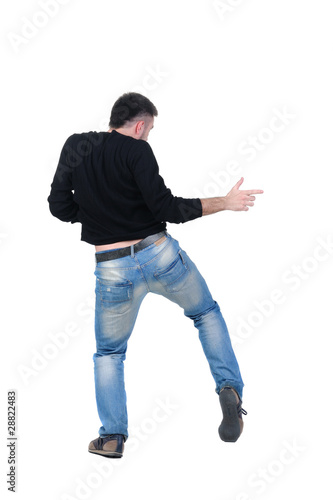 Young man dancing. Rear view.