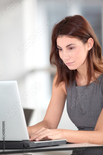 Executive woman working on laptop computer © goodluz