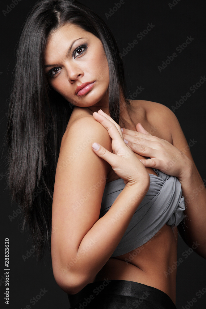 Brunette with long hair posing on black background. Brunette with long hair posing on black background.