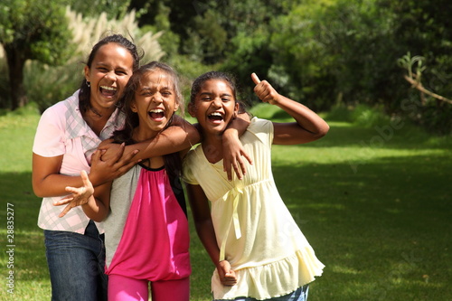 Happy school girls have fun laughing out loud with thumbs up