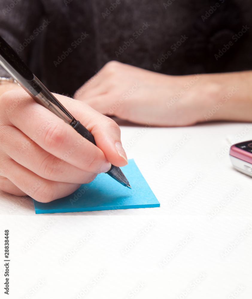 Woman writing on a notepad Woman writing on a notepad