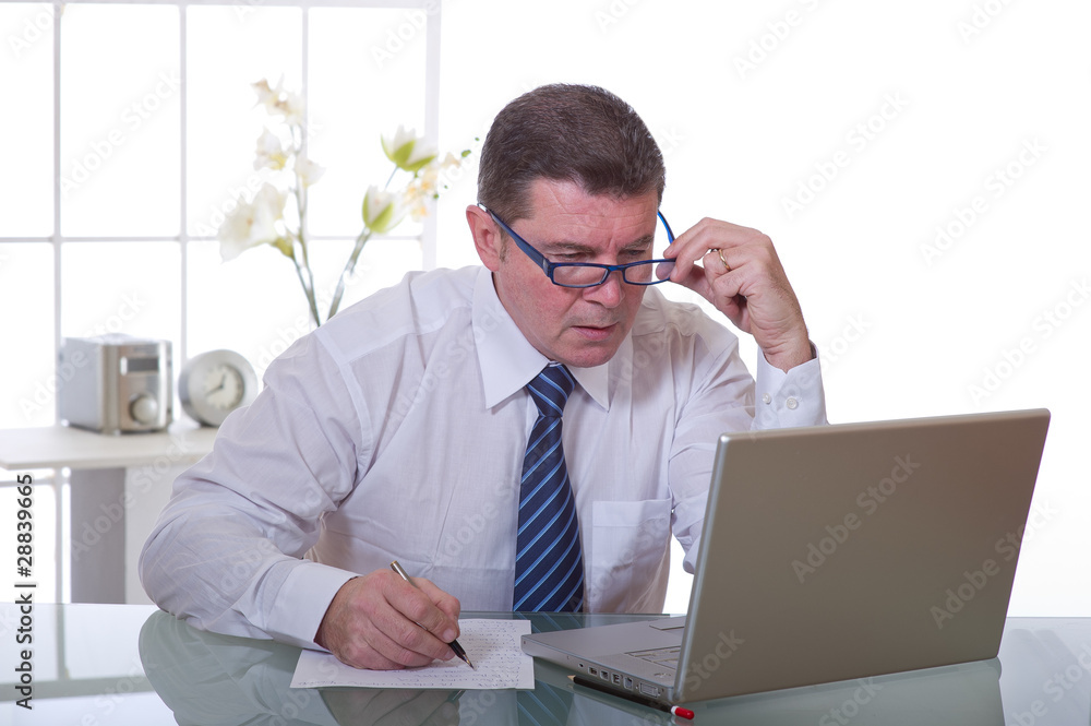 manager with glasses writing manager with glasses writing