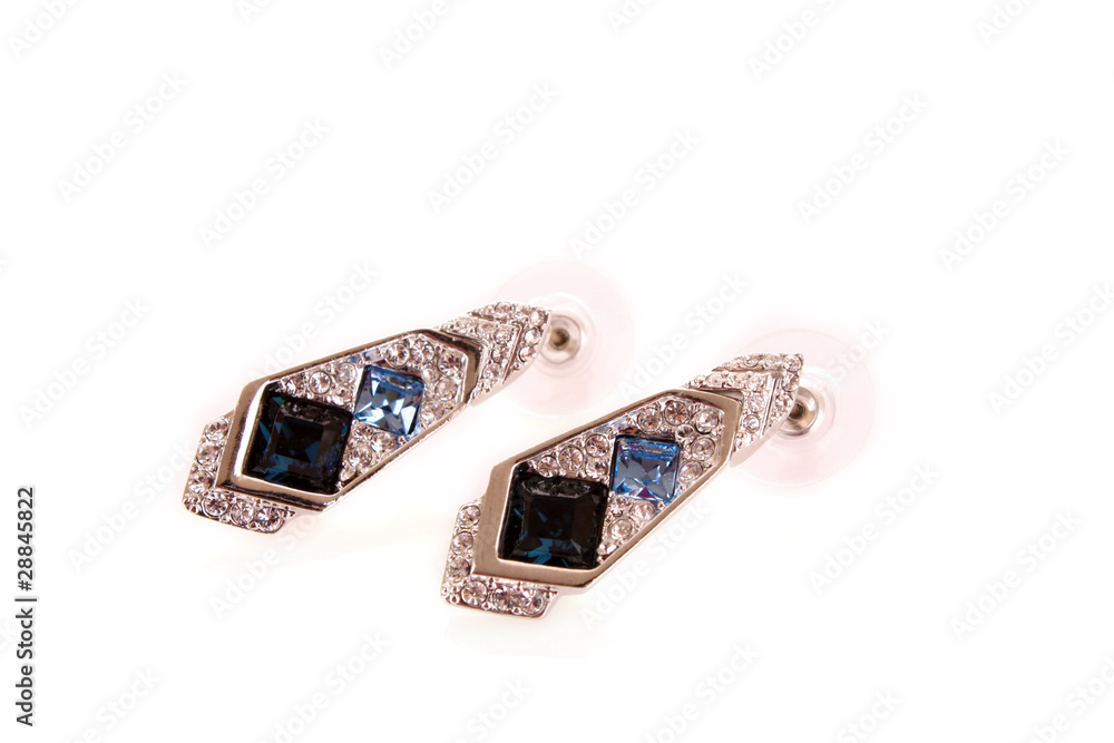 Beautiful earrings with gems on white background Beautiful earrings with gems on white background