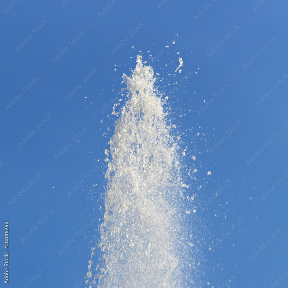 Water Flowing From Fountain Against Clear Blue Sky