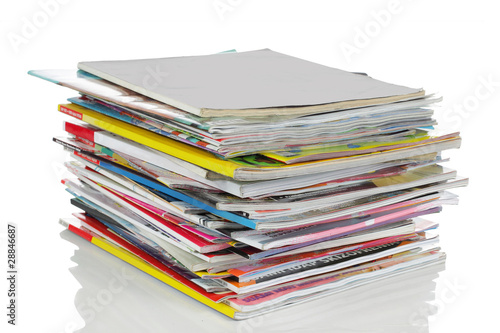 shot of stack of magazines isolated over white