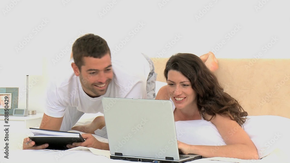 Couple laughing after watching a video on the laptop Couple laughing after watching a video on the laptop
