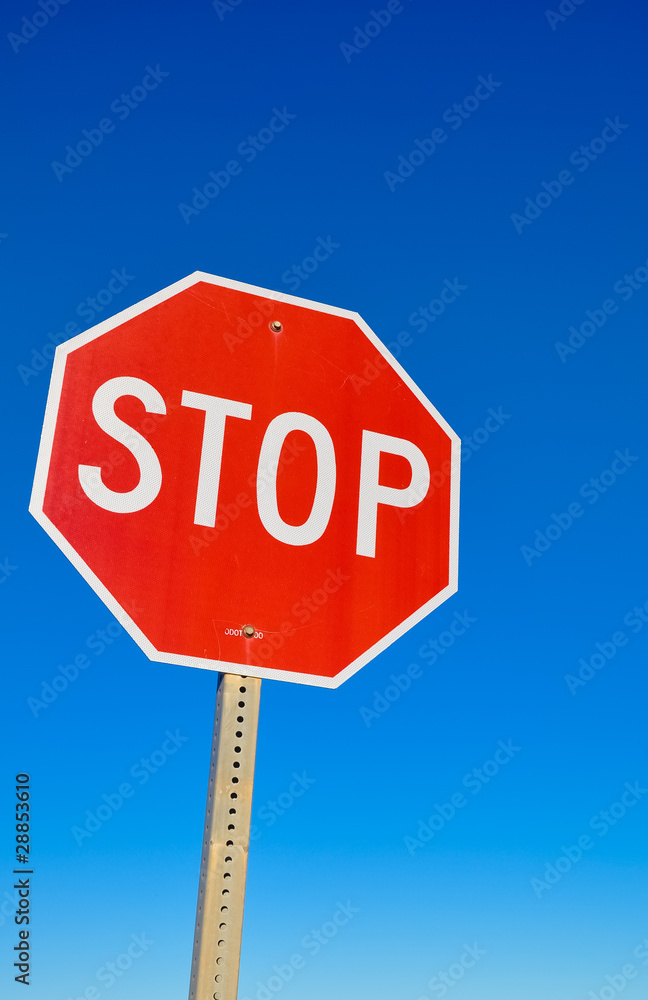 Stop signal against the blue sky