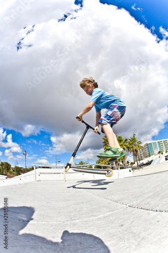 boy with scooter is going airborne