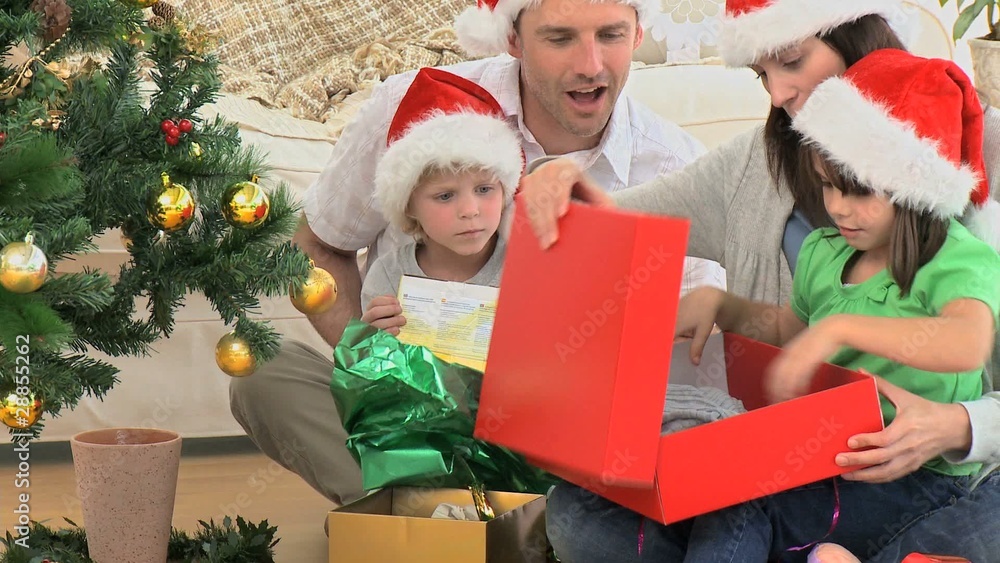 Lovely family opening Christmas presents Lovely family opening Christmas presents