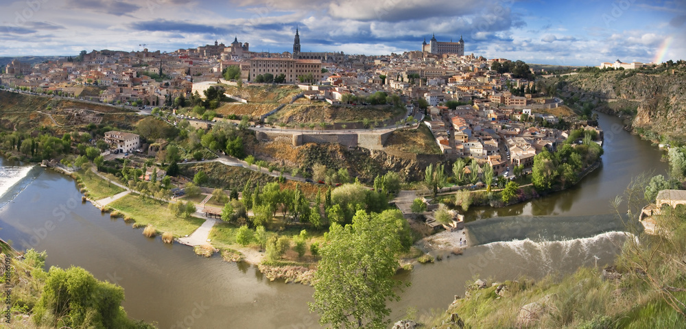 Panoramic view in the old city in Toledo with rainbow. Spain