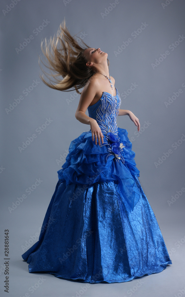 Fototapeta premium A young and sexy blond bride in a beautiful blue dress